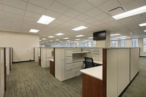 An office with beige cubicles