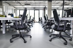 A office with black color chairs in it.