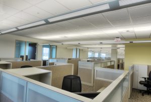 A nice infrastructure of office workstations having different light color walls.